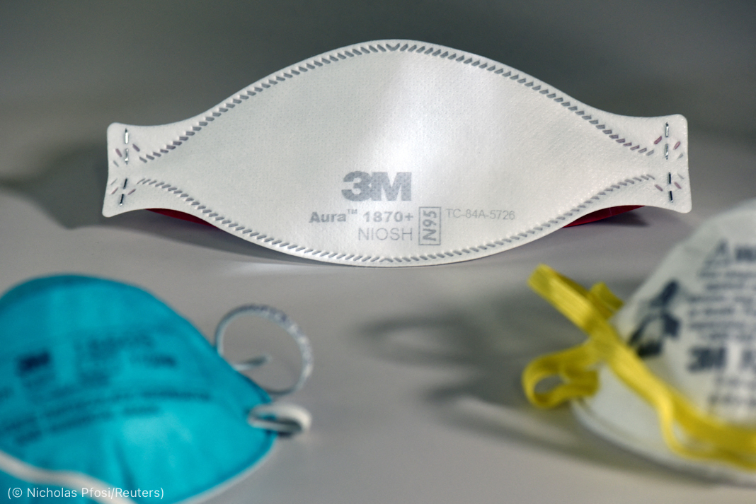 Three different 3M respirator masks on flat surface (© Nicholas Pfosi/Reuters)