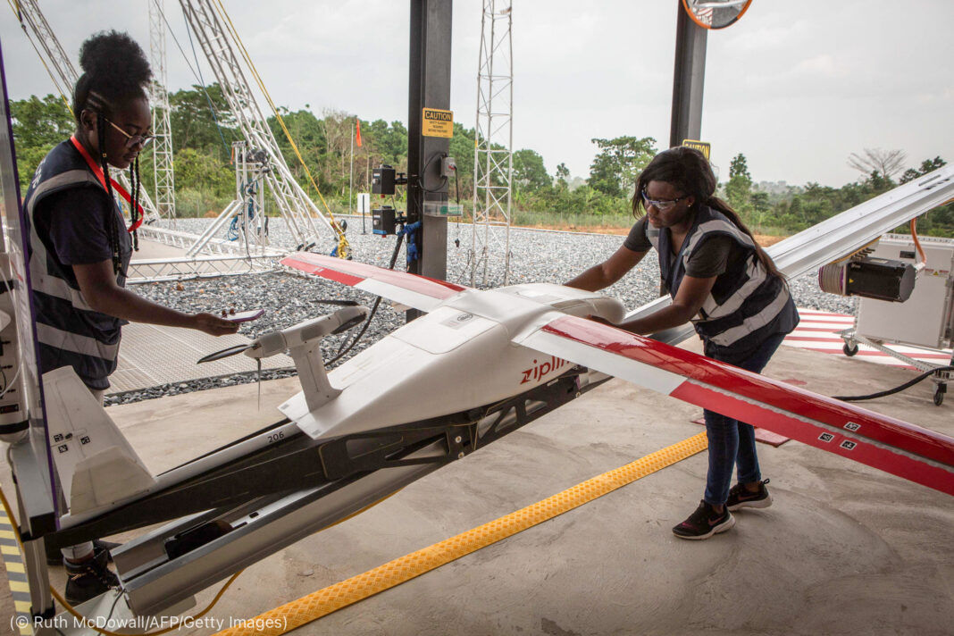 Two women preparing unmanned air vehicle before a flight (© Ruth McDowall/AFP/Getty Images)